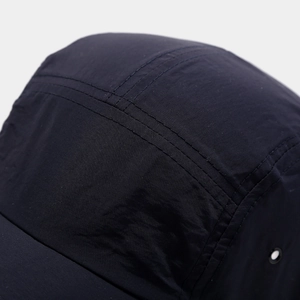 Detailed close-up of premium stitching and breathable eyelet on minimalist baseball cap