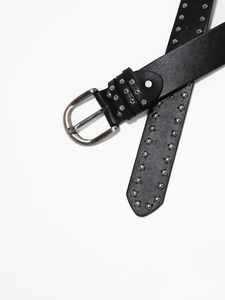Detailed view of Y2K punk black leather belt with silver rivets and metal D-ring buckle