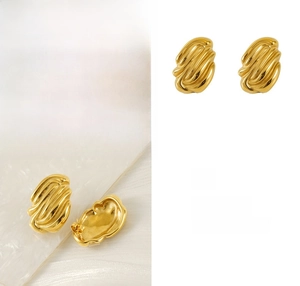 Macro detail of gold irregular wavy earrings with polished 18K stainless steel texture