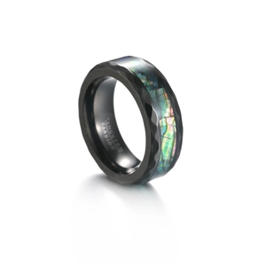 Detail of black tungsten carbide ring featuring faceted edges and abalone shell inlay