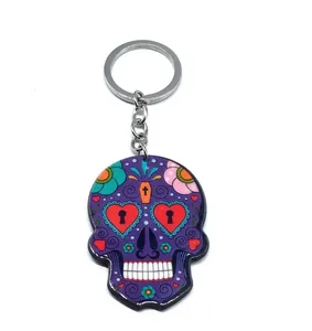 Macro view of purple Mexican sugar skull keychain with floral patterns and silver ring