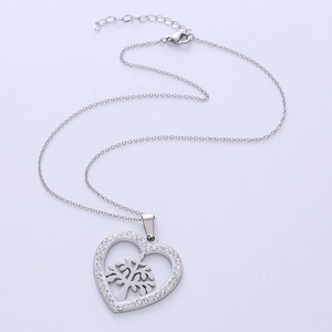 Silver heart pendant necklace with tree of life design and sparkling crystal inlay