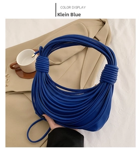 Detail shot of the knotted noodle shoulder bag in striking Klein Blue faux leather