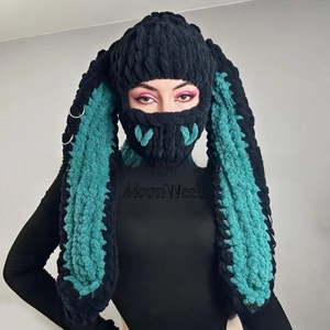 Detailed close-up of handmade crochet rabbit ear balaclava with metal ring accents