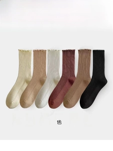 Detailed flat lay of six colors cotton socks with ruffle cuffs and ribbed texture