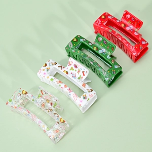 Set of four Christmas hair claws with festive prints in red, green, white, and clear colors