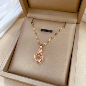 Elegant rose gold clover necklace with sparkling crystals in a champagne gift box