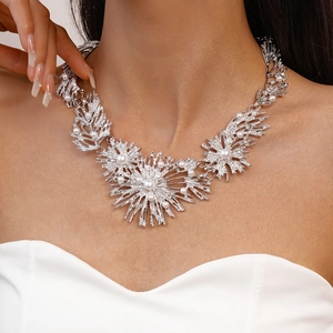 Detail of silver metallic flower necklace with faux pearls on neck model