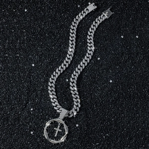 Silver iced-out Cuban chain necklace with a rhinestone cross and thorns round pendant