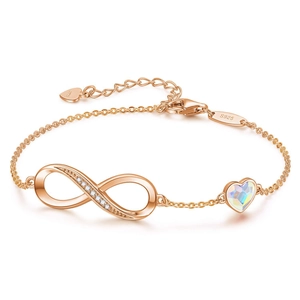 Macro detail of S925 sterling silver infinity bracelet with crystal heart and lobster clasp