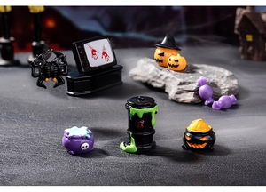 Miniature Halloween resin figurines including pumpkin, skull cauldron, and spooky TV set