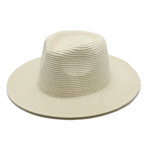 Close-up of fine paper straw weaving texture on a classic beige wide-brim Panama hat