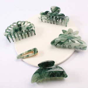 5-piece set of dark green marble patterned acetate hair clips and claws on white display