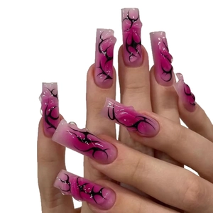Long square pink gradient press-on nails with black tribal patterns and 3D texture