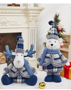 Detailed close-up of Christmas snowman plush doll with blue plaid fabric and knitted texture