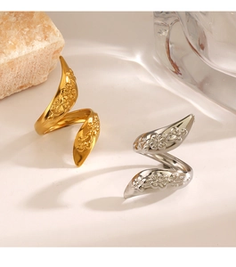 Detailed view of spiral open rings with floral embossing in gold and silver finish
