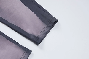 Close-up of purple and grey patchwork long sleeve jumpsuit showing high elastic fabric texture