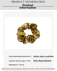 Detail view of yellow daisy pattern hair scrunchie with 9.5cm diameter and fabric texture