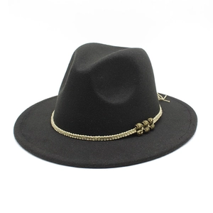 Close-up of black wool fedora with beige braided rope and bronze antique metal beads