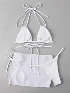Detailed view of white three-piece bikini with drawstring ties and sheer mesh sarong skirt