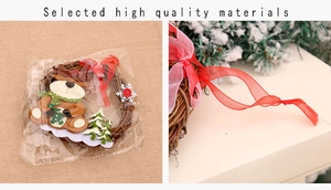 Detail of Christmas rattan wreath with reindeer, green tree and textured red ribbon