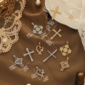 Cross and heart pendants with pavé zircons in gold and silver finish on silk