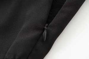 Macro view of a seamless invisible zipper on premium black lace spliced fabric