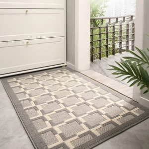 Grey Nordic rectangular doormat with white geometric patterns on a grey tiled floor