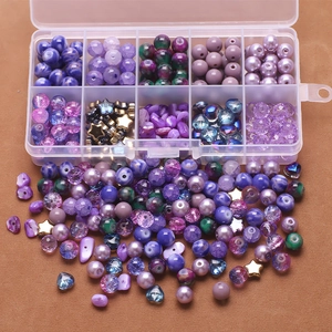 Macro view of purple gradient glass beads in a 10-grid DIY jewelry making storage kit