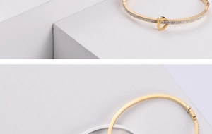 Macro shot of gold and silver heart-shaped bracelets with sparkling zircon clasp detail
