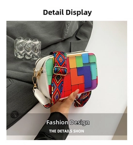 Detail view of colorful geometric pattern and bohemian style wide strap on the shoulder bag