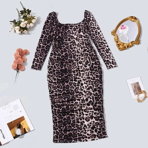 Flat lay of a leopard print long sleeve midi dress with stylish lifestyle accessories