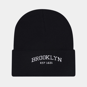 Detailed close-up of Brooklyn embroidery on a black ribbed knit beanie cap