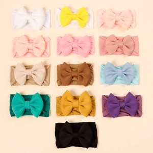 Detailed flat lay of 13 colorful high-elastic nylon baby bow headbands for girls