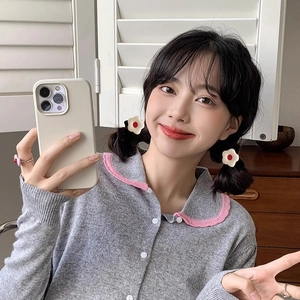 Pink dopamine Y2K flower hair ties and ring set for girls shown in a mirror selfie