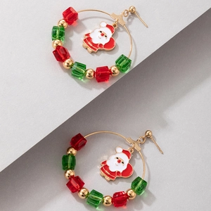 Detailed view of Christmas earrings with colorful beads and Santa Claus pendant on grey base