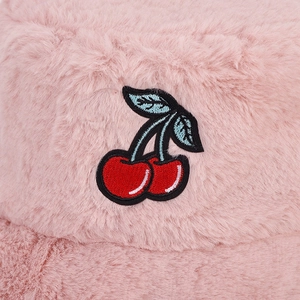 Pink plush bucket hat with red cherry embroidery detail for winter casual style