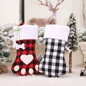 Christmas stockings shaped like pet paws in red and black plaid with plush white faux fur trim