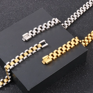 Detailed shot of three stainless steel watch strap necklaces in silver, gold, and bicolor
