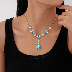 Detailed view of luxury necklace with light blue pear-cut stones and sparkling crystals