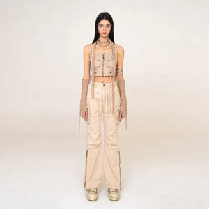 Detail of khaki cargo suit with multi-pocket vest and high-waist flared pants