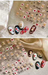 Detail of vintage Alice Rabbit nail stickers with poker and tea cup embossed designs