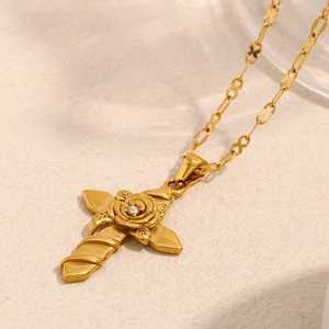 Detail of 18K gold plated cross pendant necklace with centered rose and zircon stone