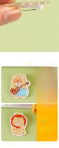Close-up of cream yellow bear acrylic brooches showing digital printing details