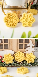 Close-up of yellow snowflake-shaped cookies made with mini Christmas pastry stamp tools