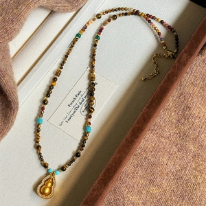 Tiger eye stone necklace with gold-plated gourd pendant and sparkling zircon accents