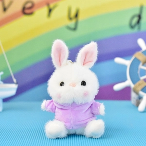 Detailed view of a small white plush rabbit keychain wearing a cute purple hoodie