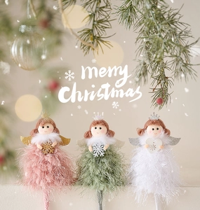 Detailed view of three plush Christmas angel dolls in pink, green, and white colors