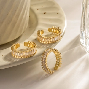 18k gold plated open rings with square zircon stones on a white ceramic tray