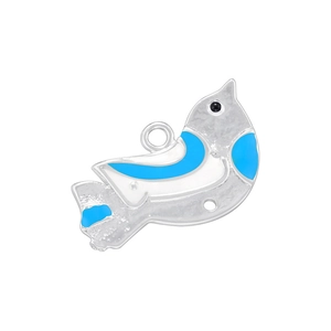 Close-up of silver bird pendant with blue enamel detailing and circular top loop